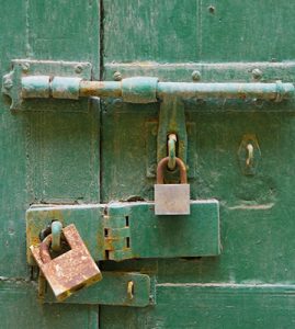 Closed-up of a house-gate with locks that represent "protect your home" blog.