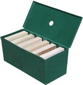 Green box of termite trap with timber woods placed inside and as the featured image of "termite traps work" blog.